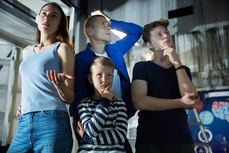 Interested family contemplating solving conundrums in escape room